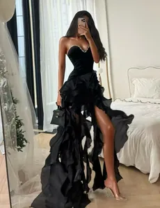 Sexy strapless black evening dress with elegant tiered ruffles and high side slit detail.