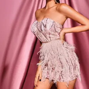 Elegant pink strapless sequin evening dress with glamorous feather trim for parties