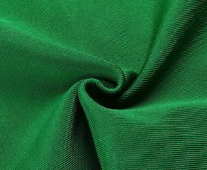 Macro close-up of high-quality green bandage dress fabric showing dense knit texture