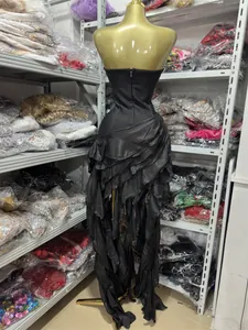 Rear view detail of a sexy black strapless ruffled evening dress with asymmetrical side slit