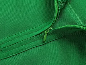 Detailed macro view showing the matching concealed zipper on a green bandage dress