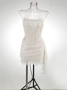 Detailed side view of elegant white lace corset dress featuring a draped sash design