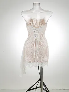 Detailed back view of an elegant white lace corset mini dress with lace-up closure