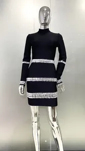 Close-up view of the sparkling crystal embellishments on this black bandage dress.