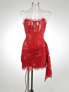 Elegant red lace corset mini dress featuring sheer panels and long draped side detail