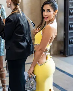 Sexy lemon yellow halter dress with rhinestone trim and side cutouts for party wear