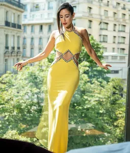 Detail view of the yellow dress showing the sexy cut-out waist and rhinestone trim