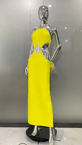 Lemon yellow halter maxi dress with rhinestone cut-out details on a chrome mannequin