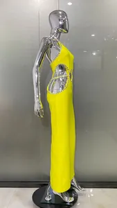 Side view of lemon yellow halter dress featuring sexy cutouts and rhinestone edges
