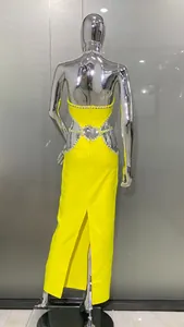 Detailed back view of a lemon yellow halter dress with rhinestone cut-out trim and back slit