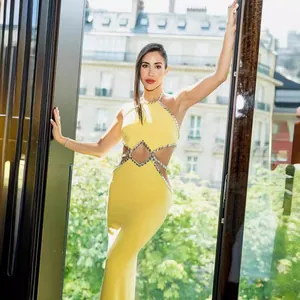 Sexy lemon yellow halter neck maxi dress featuring rhinestone trim and waist cut-outs