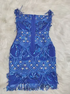 Detail view of blue sequined party dress with intricate lace embroidery and fringes