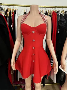 Red halter neck party dress with rhinestone trim and silver buttons shown on mannequin