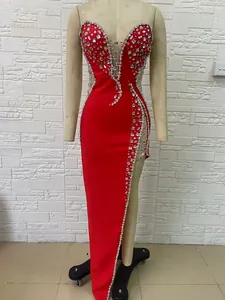 Front view detail of luxury red evening gown with elaborate rhinestone beading on mannequin