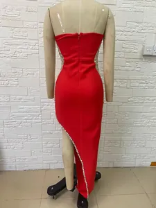 Back view of a red strapless dress with rhinestones and high slit detailing
