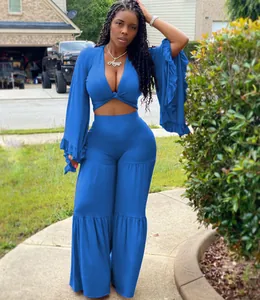 Two-piece blue set featuring a ruffled long-sleeve crop top and tiered wide-leg pants