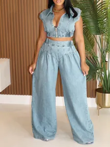 Detail of a chic light blue denim two-piece set featuring a cropped vest and wide-leg pants