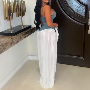 Back view of denim camisole top and white pleated wide-leg pants two-piece set for women