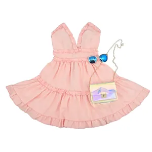Pink sleeveless ruffle mini baby doll dress shown as a flat lay with accessories