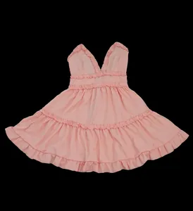 Detail showing the pink sleeveless backless mini doll dress with elegant ruffle trim