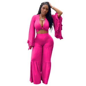 Full view of hot pink two-piece set with flared sleeves and tiered wide-leg trousers