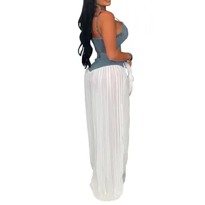 Stylish side profile of a denim crop top paired with white pleated sheer wide-leg pants.