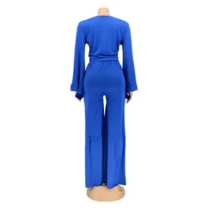 Back view of royal blue long sleeve two-piece set featuring wide-leg flared trousers