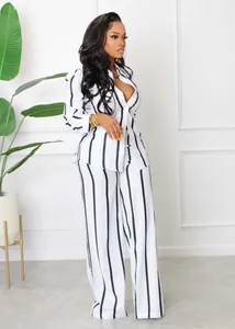 Elegant black and white vertical striped shirt and wide-leg trousers two-piece set.