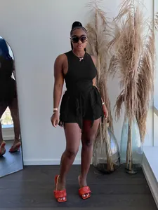 Detailed view of the black sleeveless top and fringe-hemmed shorts summer outfit set