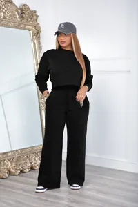 Detail view of a black women's two-piece sweatshirt set with cropped top and wide trousers
