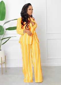 Detailed view of yellow and white striped two-piece shirt and wide-leg pants set