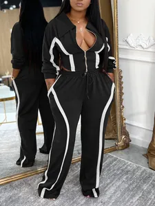 Two-piece black and white women's sports tracksuit with a zip-up jacket and pants.