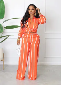 Stylish orange and white striped two-piece set with long sleeve shirt and wide leg pants