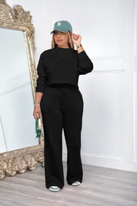 Detail of black two-piece tracksuit set with cropped sweatshirt and wide-leg pants