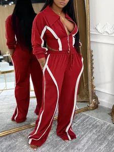 Detailed view of red cotton two-piece tracksuit with white stripe accents for women