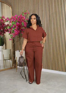 Full-length view of a stylish terracotta linen short-sleeve shirt and wide-leg trousers set