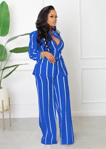 Detail view of royal blue striped two-piece shirt and wide-leg pants set on a model