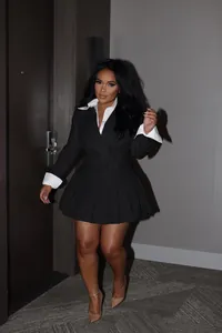 Elegant two-piece black blazer and pleated mini skirt set for office wear