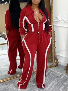 Detail view of red and white sports tracksuit set featuring front zipper jacket and pants