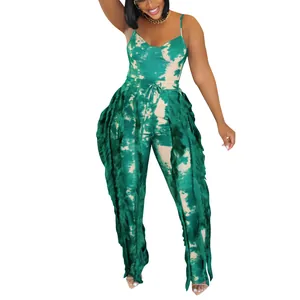 Detail of green tie-dye women's jumpsuit with side fringe tassels and camisole top