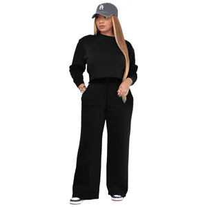 Model wearing the black long-sleeve crop sweatshirt and wide-leg jogger pants set