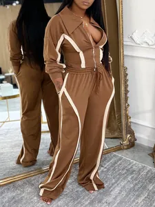 Two-piece brown tracksuit set with cream contrast piping detail for autumn and winter.