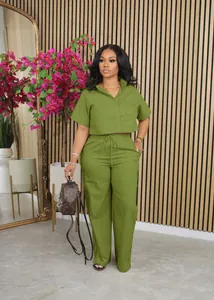 Full body shot of a stylish green linen two-piece set featuring a crop shirt and trousers