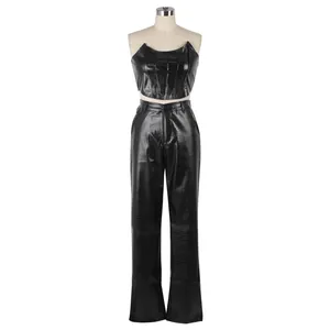 Detail view of two-piece black faux leather set with crocodile skin texture top and pants