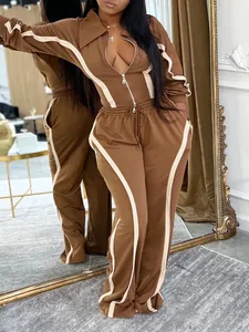 Detail of women's brown and cream two-piece cotton tracksuit with zip-up jacket.