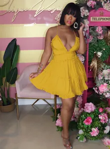 Sexy sleeveless deep V-neck tiered babydoll mini dress in mustard yellow on model