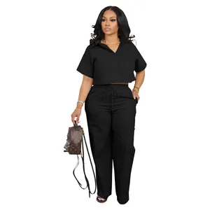 Full view of women's black two-piece linen set with cropped shirt and wide-leg trousers
