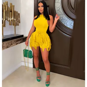 Trendy yellow two-piece outfit featuring a sleeveless top and fringe detail shorts