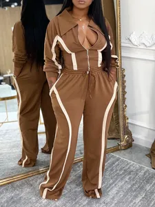 Detail view of a brown and cream two-piece tracksuit with stripe accents and zipper.