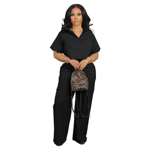 Front view of women's black two-piece linen set featuring short-sleeve shirt and wide-leg pants
